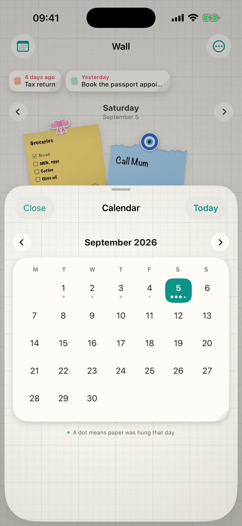 The month grid with a dot under every day that has paper on it